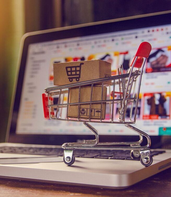 Shopping cart in front of an online store screen